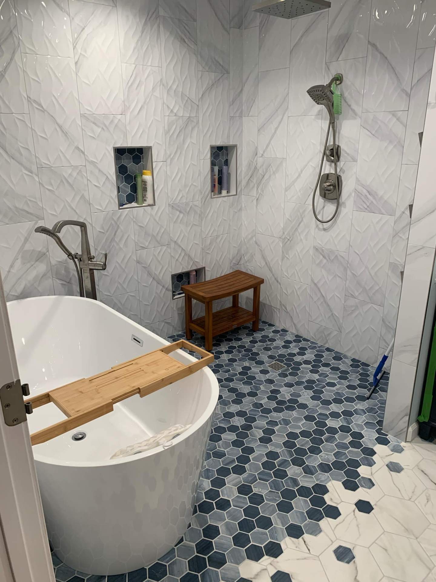 Blue hexagonal tile bathroom with freestanding tub